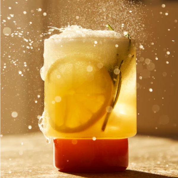 Fresh alcohol-free cocktail with a slice of lemon and a sprig of mint