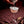 Cocktail being poured into a glass with a dark background